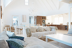 Light, airy, coastal inspired living room designed by Ocean County custom home builder